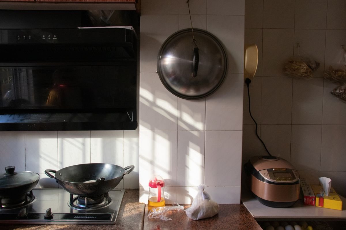Cozinha moderna com panelas e cooktop, ambiente ideal para usar panela de pressão elétrica no dia a dia